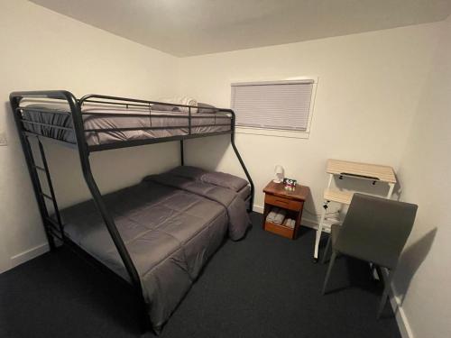 a bedroom with a bunk bed and a desk and a chair at Tree Star Motel in Monroeton