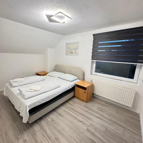 a small bedroom with a bed and a window at Villa RELAX Miševići in Sarajevo