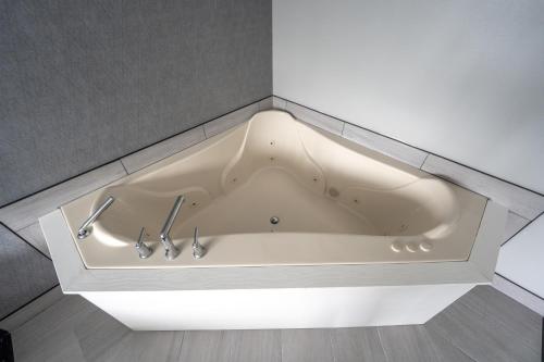a white bath tub in the corner of a room at Seaport Resort and Marina in Fairhaven