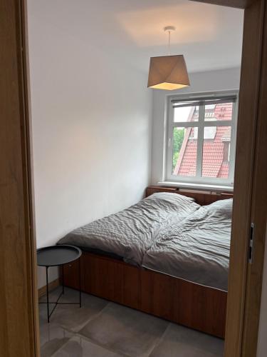 a small bedroom with a bed and a window at SWP Plac Solny 4 z klimatyzacją in Głogów