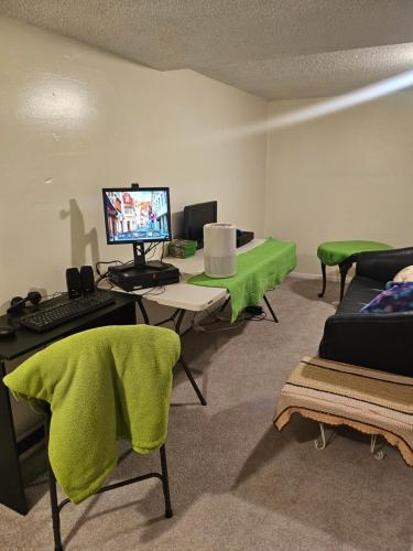a room with a desk with a computer and a couch at Plantlife LLC Lodge D in Minneapolis