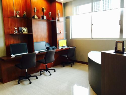 an office with two desks with two monitors and two computers at Indra Regent Hotel in Bangkok