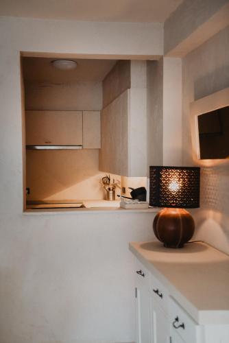 a kitchen with white cabinets and a light on the counter at Vertry at Sea, Luxury Apartment Knokke in Knokke-Heist