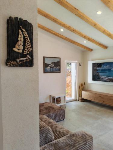 a living room with two beds and a tv at Casa Bellea in Belej