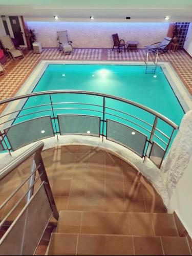 a swimming pool with a metal rail around it at Alpin Wellness & Spa Vlašić in Vlasic