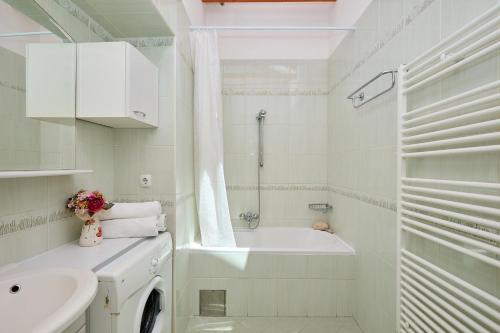 a white bathroom with a tub and a sink at Hedera Estate Hedera A34 in Dubrovnik
