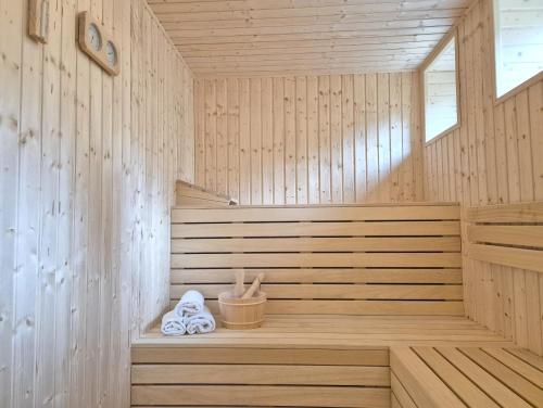 a wooden sauna with two towels on a bench at Sarnówka KDN in Rajcza
