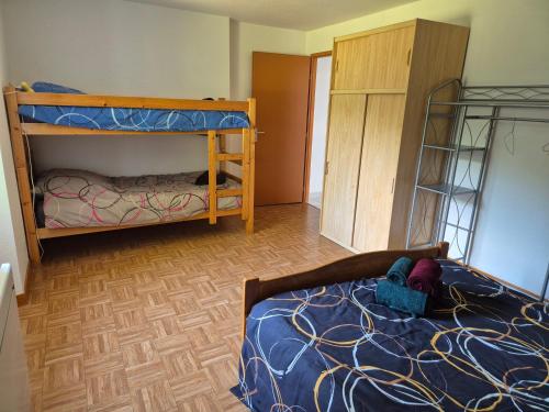 a bedroom with a bed and a bunk bed at Gites les marronniers in Marigny