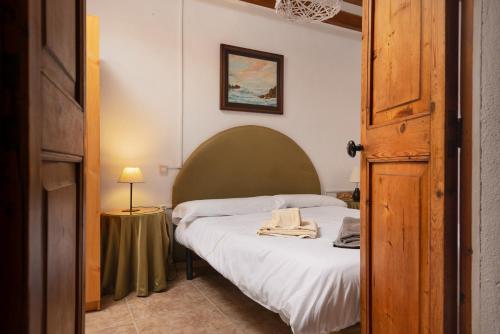 a bedroom with a bed with a towel on it at Sunset private Eco-Villa Can Vey in Inca