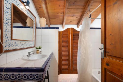 a bathroom with a sink and a mirror at Sunset private Eco-Villa Can Vey in Inca