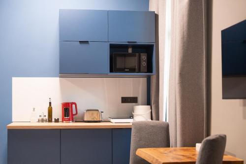 a kitchen with blue cabinets and a counter top at Revelton Ostrava in Ostrava