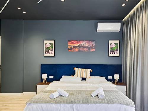 a bedroom with a large bed with two pillows on it at Vila Andrea in Himare