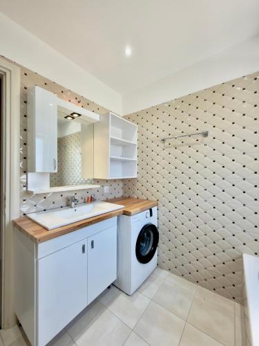 a kitchen with a washing machine and a washer at Vila Andrea in Himare