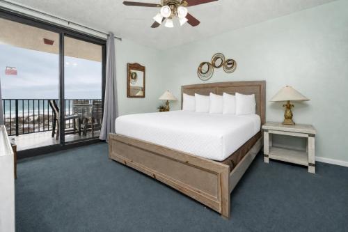 a bedroom with a large bed and a balcony at Phoenix X 304 in Orange Beach