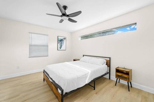 a bedroom with a bed and a ceiling fan at Ocean Retreat C in Boynton Beach