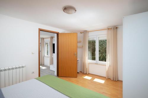 a bedroom with a bed and a wooden door at Pula Istria Apartments in Pula