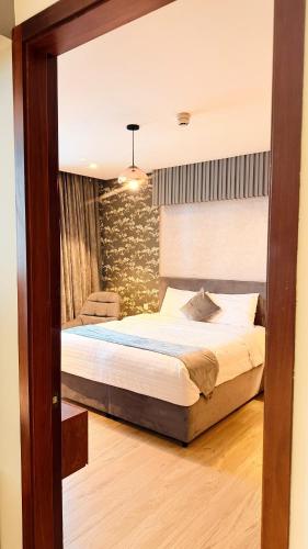 a bedroom with a large bed in a room at Millennium Private Apartment in Salalah