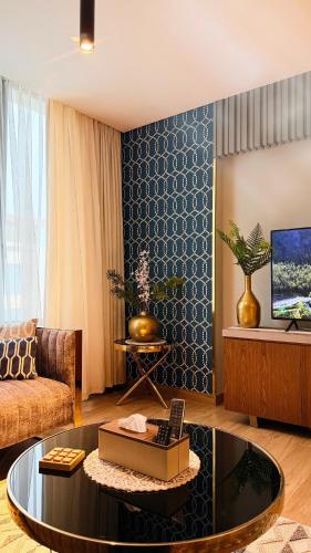 a living room with a couch and a coffee table at Millennium Private Apartment in Salalah
