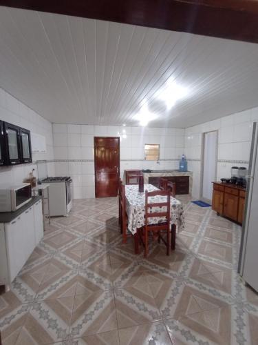 a kitchen with a table and chairs in a room at Sítio de Vavá in Gravatá
