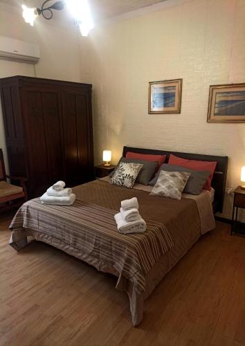 a bedroom with a large bed with towels on it at Collina Blu in Cuglieri