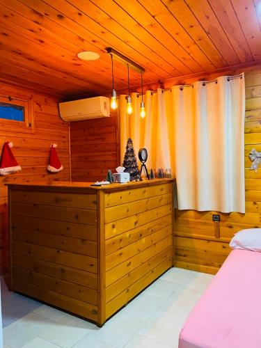 a bedroom with a bed and a dresser at Ferme Sacrée Nature in Ben Slimane
