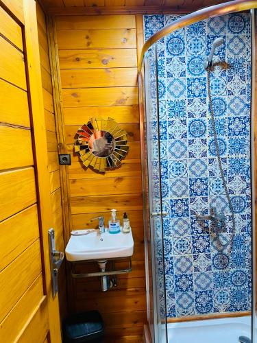 a bathroom with a sink and a shower at Ferme Sacrée Nature in Ben Slimane