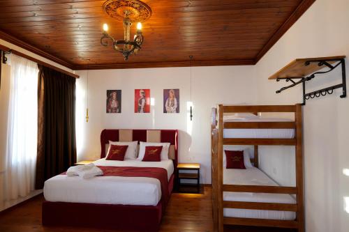 a bedroom with two beds and a bunk bed at Fabiani Boutique Hotel Castle Gate in Krujë