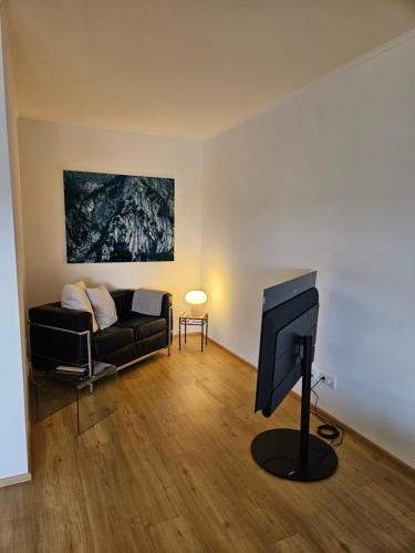 a living room with a couch and a television at Apartment 416 mit Pool in Lahnstein