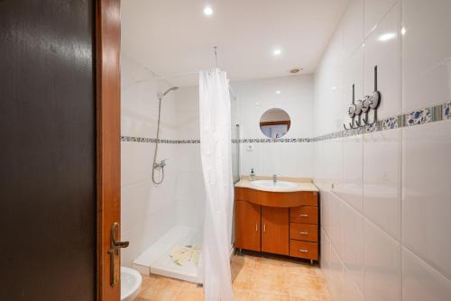 a bathroom with a shower and a sink and a toilet at Can Calco old town in Alcudia