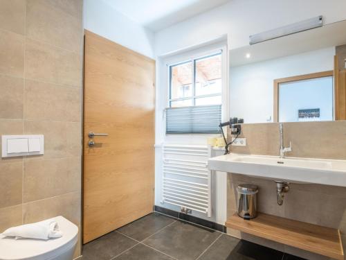 a bathroom with a sink and a mirror at Luxury Tauern Suite Walchen Kaprun 8 in Walchen