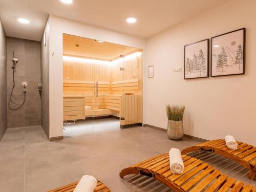 a large bathroom with a shower and a bed at FIIF Pinzgau in Wald im Pinzgau