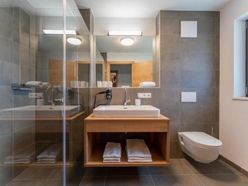 a bathroom with a sink and a toilet at Chalet Joep in Wald im Pinzgau