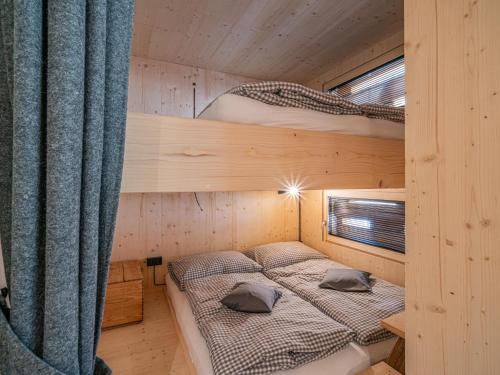 two bunk beds in a wooden room with a window at Raneburg 4 Futterhaus in Matrei in Osttirol