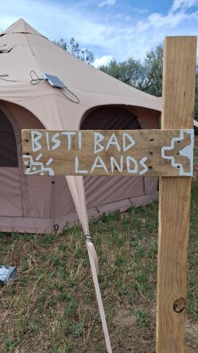 a sign that says fish bad laws in front of a tent at Bisti Badlands Tent in Farmington