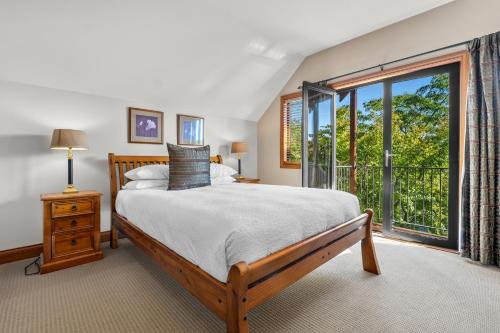 a bedroom with a bed and a large window at Lansdown Apartments in Wanaka