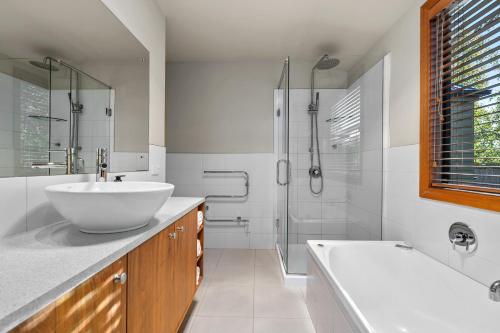 a bathroom with a sink and a tub and a shower at Lansdown Apartments in Wanaka