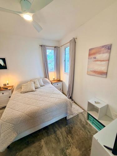 a bedroom with a bed and a window at Acacias PDD in Punta Del Diablo
