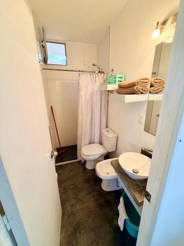 a bathroom with two toilets and a sink at Acacias PDD in Punta Del Diablo