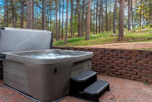 a bath tub sitting next to a brick wall at Modern Lodge- BHBungalows Main in Custer