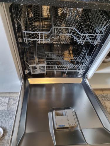 a dishwasher with its door open with food inside at Nice appartment in city center Gol,free Wifi and electric in Gol