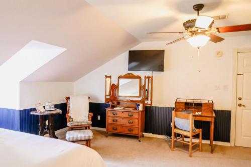 a bedroom with a bed and a dresser and a mirror at Woodrow House Bed & Breakfast in Lubbock