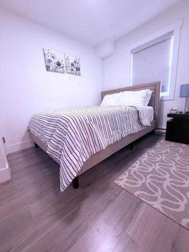 a bedroom with a large bed and a rug at Stay with Silvia in Halifax