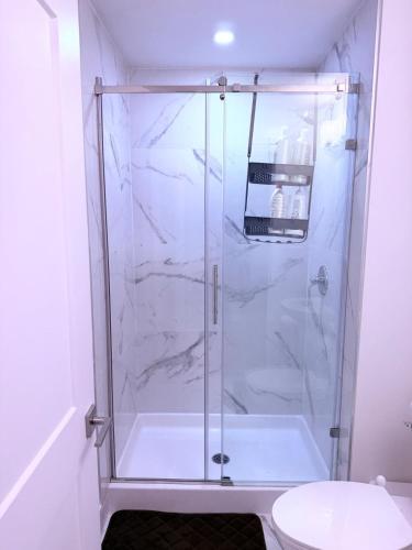 a shower with a glass door in a bathroom at Stay with Silvia in Halifax