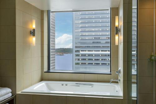 a bath tub in a bathroom with a large window at W Seattle in Seattle