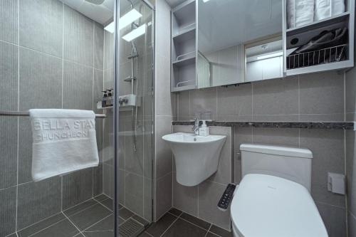a small bathroom with a toilet and a sink at Bella Stay in Chuncheon