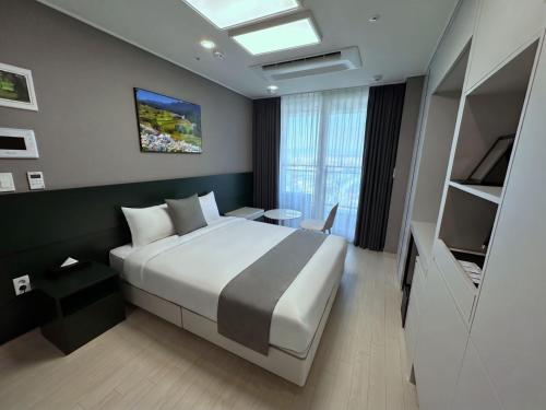 a hotel room with a bed and a television at Bella Stay in Chuncheon
