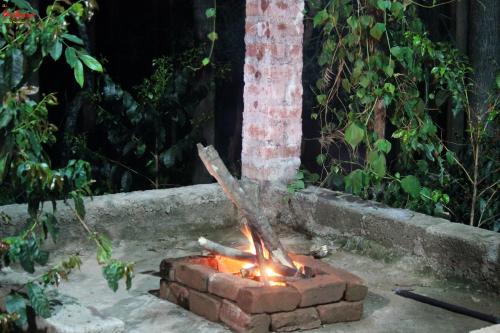a fire pit in a yard in a yard sidx sidx at The Inchara Hill View HomeStay in Chikmagalūr