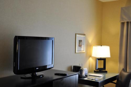 a flat screen tv sitting on a desk in a hotel room at Holiday Inn Express Hotel & Suites Christiansburg by IHG in Christiansburg