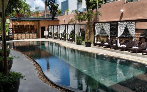 a swimming pool in the middle of a building at The Palace Indochine Hotel in Siem Reap