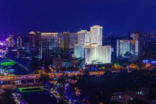 a city lit up at night with traffic at Beijing Landmark Hotel in Beijing
